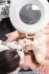 Young woman getting dermall fillers injection